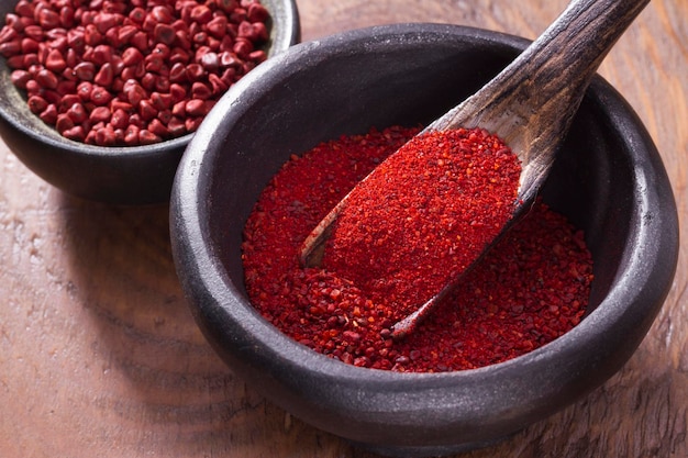 Achiote in bowl on wooden background achiote paste