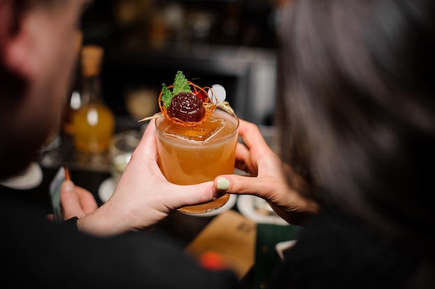 Achteraanzicht van een jong stel met een cocktailglas