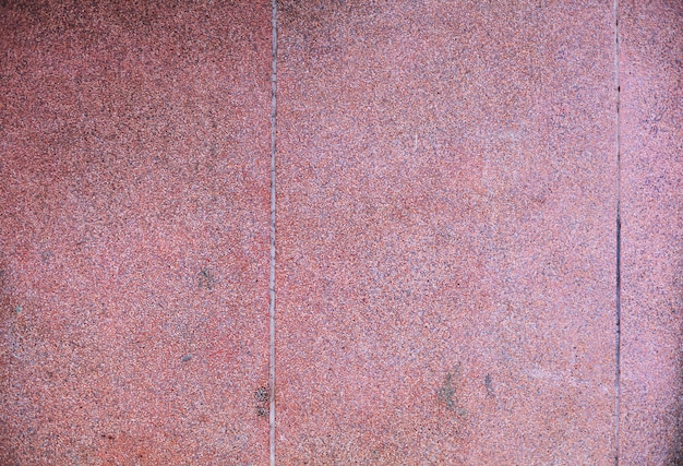 Achtergrond van de close-up de oude oude traditionele Aziatische tropische rode gekleurde grunge ruwe geweven concrete steen van de bouw