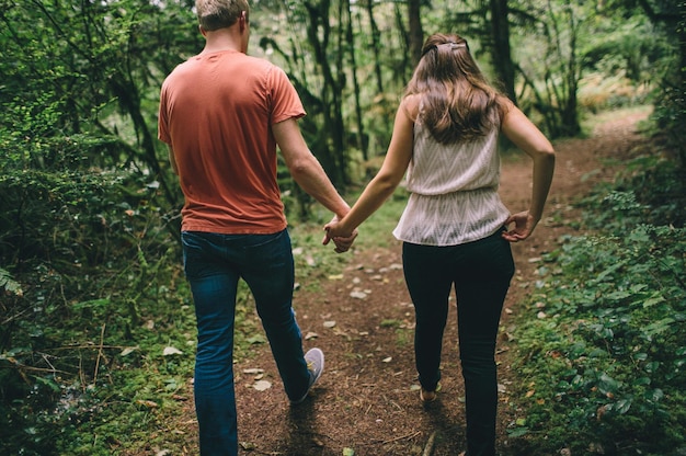 Achtergrond van een echtpaar dat in het bos loopt