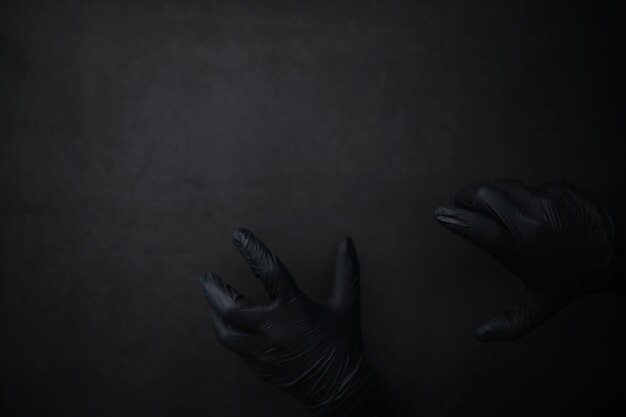 Achtergrond van handen in handschoenen Zwarte handschoenen Handgebaren in zwarte handschoenen
