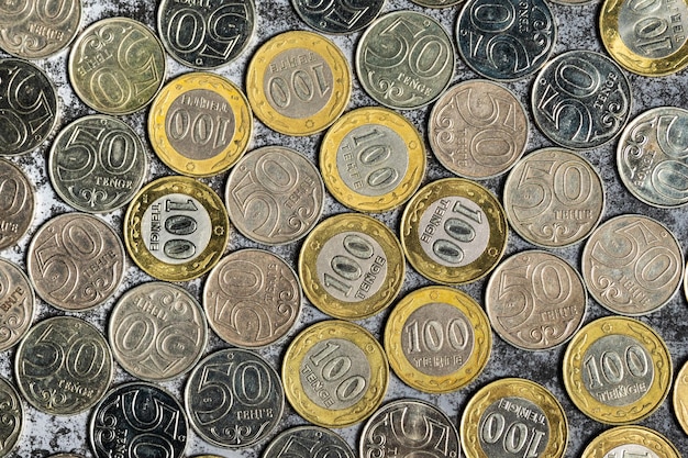 Achtergrond van Kazachstaanse munten met een nominale waarde van 50 en 100 tenge bovenaanzicht