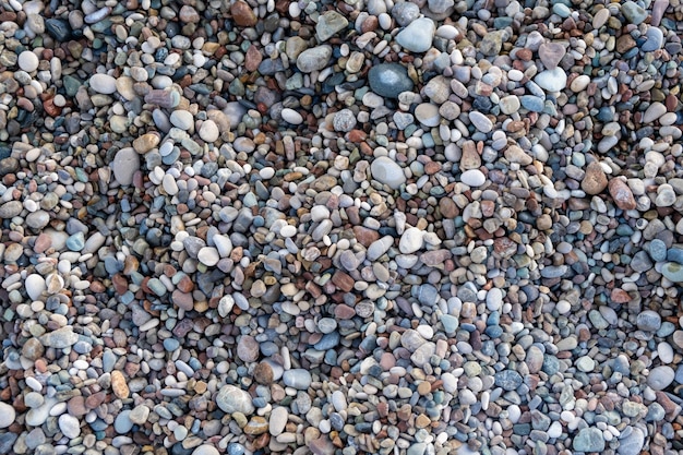 Achtergrond van kleine kiezelstenen en stenen aan de kust of in de tuin