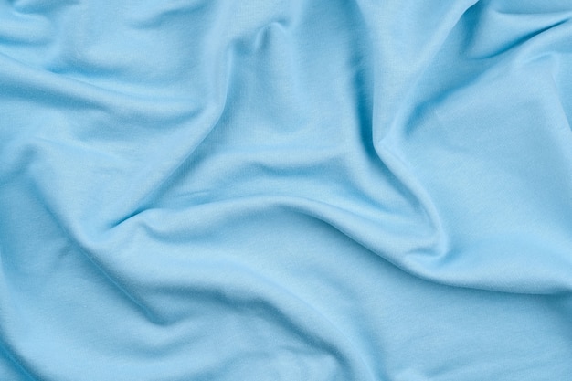 Achtergrond van lichtblauwe monochrome katoenen stof