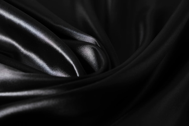 Foto achtergrond zwarte gedraaide zijdestof abstracte textuur satijnstof