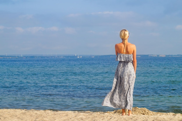 Achtergrondbeeld van een vrouw die op het strand staat