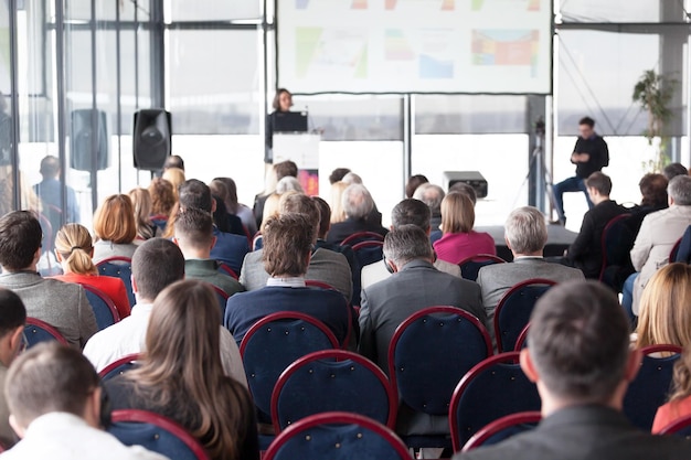 Foto achtergrondbeeld van mensen die tijdens een conferentie op stoelen zitten