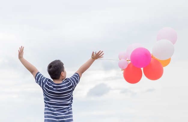 achterkant dikke jongen met kleurrijke ballon