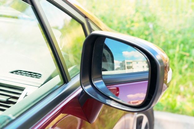 Achteruitkijkspiegel op een moderne rode auto