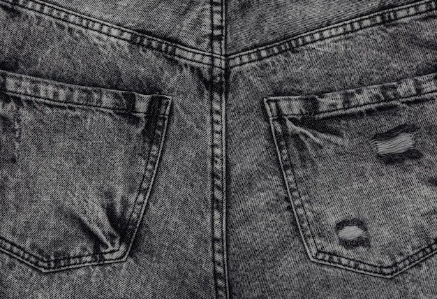 Achterzakken van grijze jeans close-up