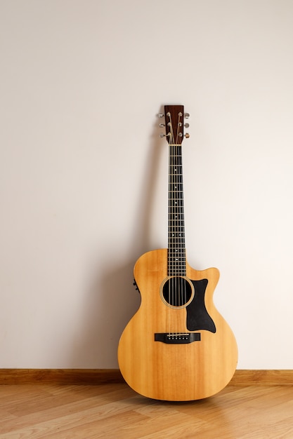 Acoustic guitar against the wall.