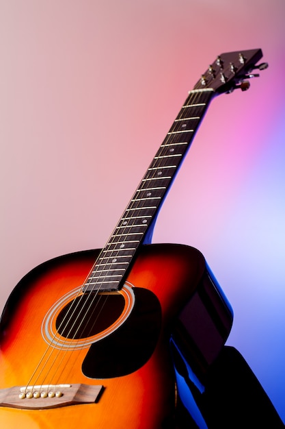 Acoustic guitar on a colored background