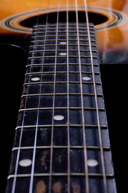 Acoustic guitar neck in the dark closeup