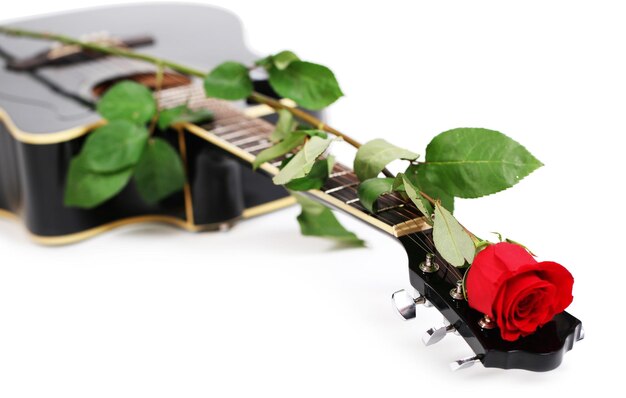 Acoustic guitar and red rose flower isolated on white
