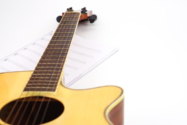 Acoustic guitar with music notes against white background Entertainment love and music concept