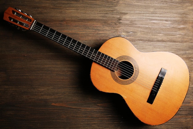 Acoustic guitar on wooden background