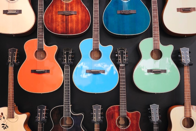 Acoustic guitars stand in a row