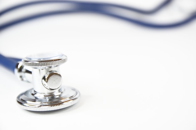 Photo acoustic head of stethoscope with small part of the soundconducting tubes blurred in the background