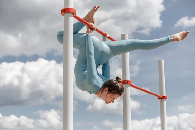 Acrobat girl in a blue suit on the street