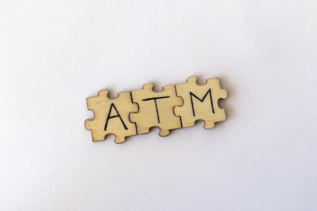 The acronym ATM which stands for At The Moment The letters written on the puzzles