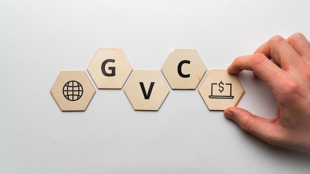 Acronym GVC or Global Value Chain Icons on wooden forms