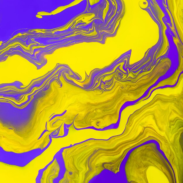 Acrylic Fluid Art. Glowing yellow waves and curls on purple background. Abstract marble background or texture.