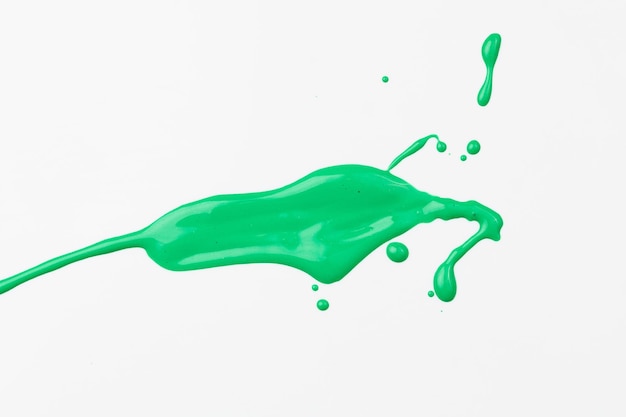 Acrylic paint blot chaotic brushstroke spot flowing on white paper background Creative green color backdrop fluid art