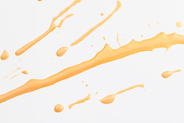 アクリル絵の具のしみホワイト ペーパーの背景に流れる混沌とした筆跡スポット創造的な黄色の背景流体アート