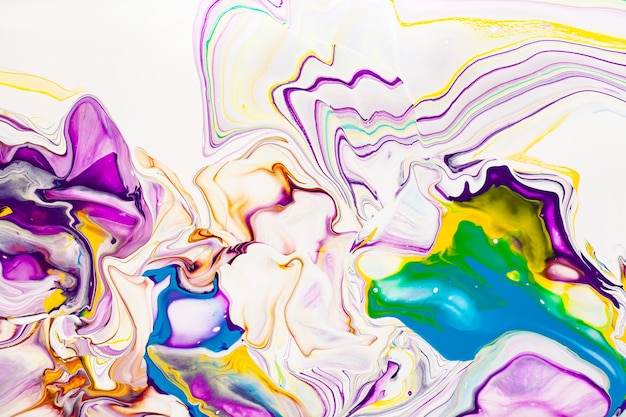 Acrylic paint waves abstract background. Rainbow marble texture. Oil paint liquid flow colorful wallpaper. Creative violet, yellow, blue fluid effect backdrop.