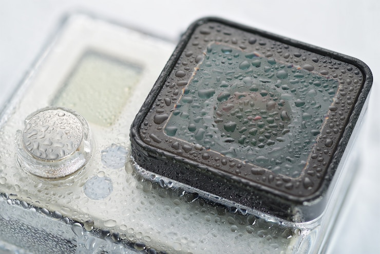 Photo action camera lens with water drops