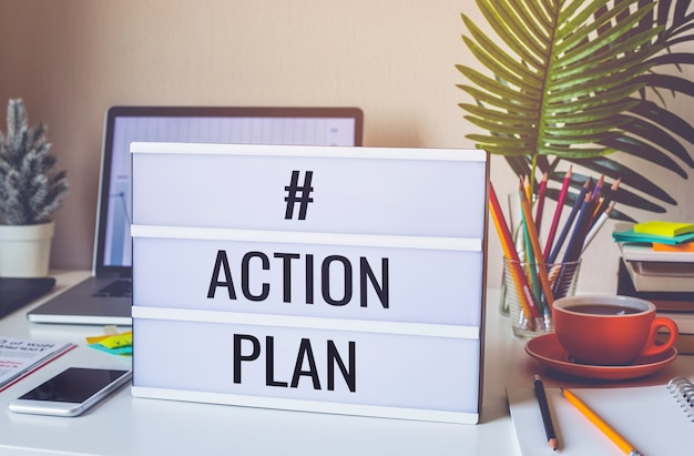 Photo action plan text on light box on desk table in home office