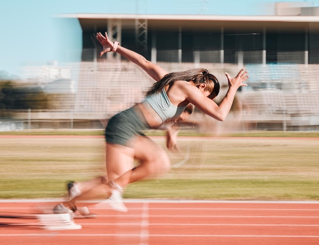 Action race and women athlete running a sprint in competition or fitness game training as energy wellness on track Sports stadium and athletic person or runner exercise speed and workout