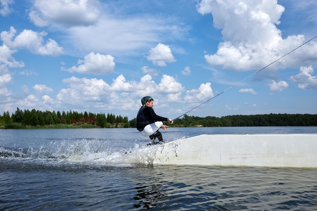 Action shot of young man with disability jumping on ramp in water