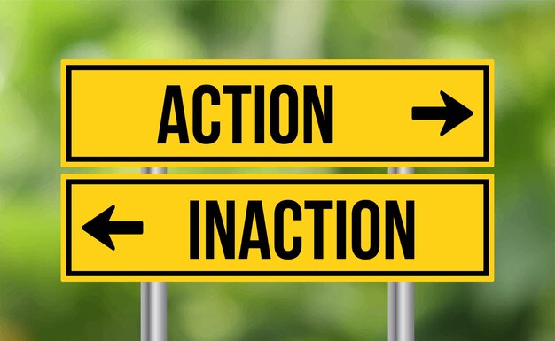 Action vs inaction road sign on blur background