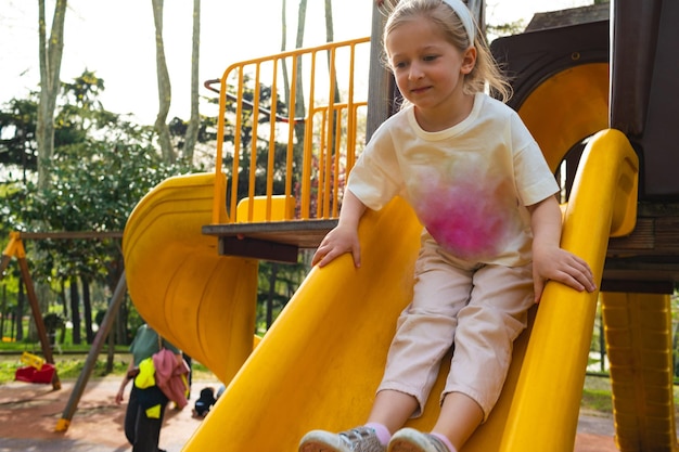 Active blonde little girl playing on a playground