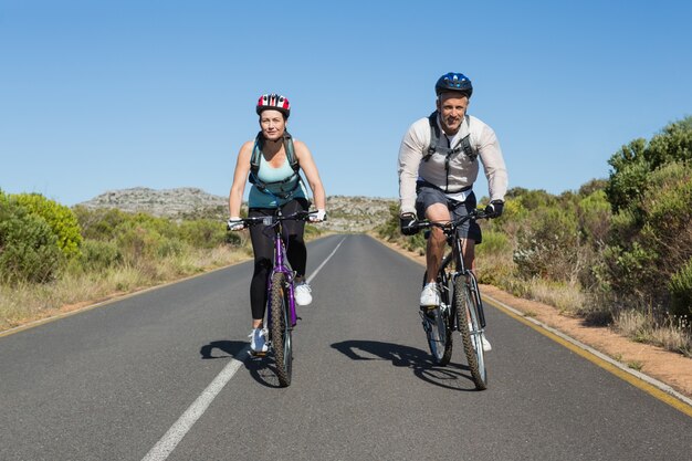 Active couple going for a bike ride in the countryside