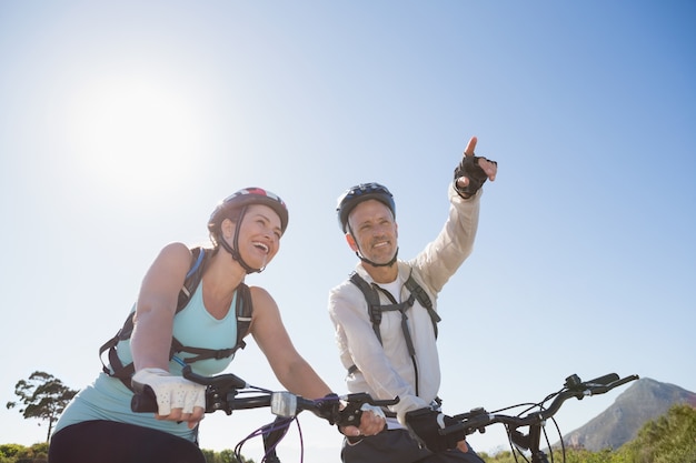 Active couple going for a bike ride in the countryside