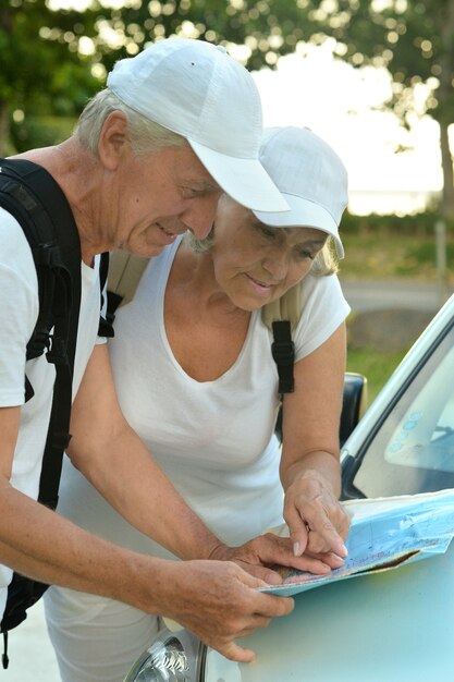 Active elderly couple looking at travel map