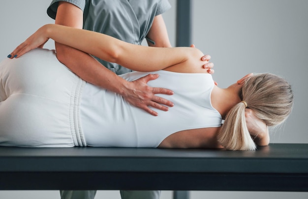 Photo active exercises woman is in health center getting help by doctor