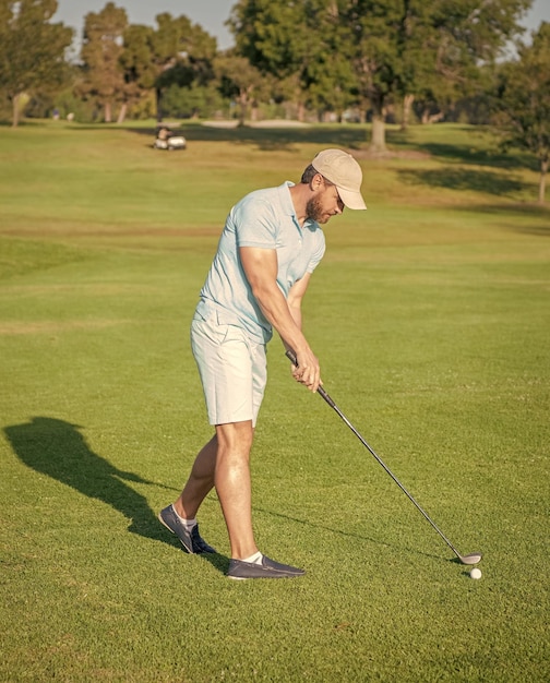 Active man playing golf game on green grass summer