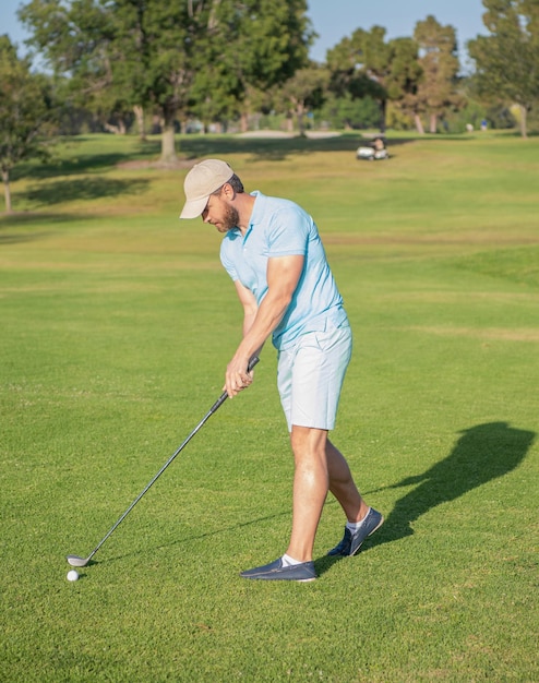 Active man playing golf game on green grass summer