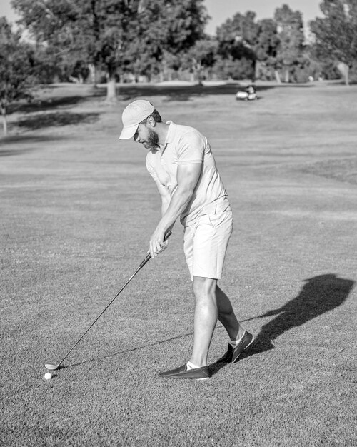 Active man playing golf game on green grass summer