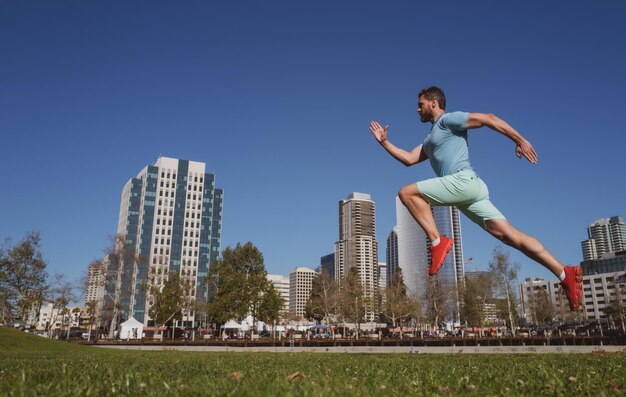 Active man runner jogging outdoor near city