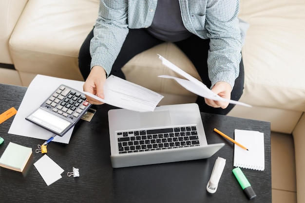 Active mature woman using a laptop for remote work from the\
home office video conference video meeting senior teacher leads\
webinar top view