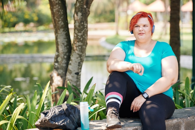 Active plus size woman in park