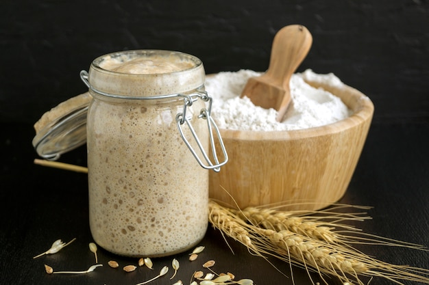 Active rye sourdough in a glass jar for homemade bread.