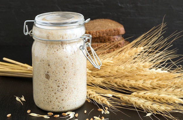 Active rye sourdough in a glass jar for homemade bread.