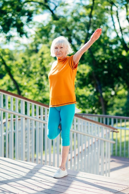 Active senior woman doing fitness in a park