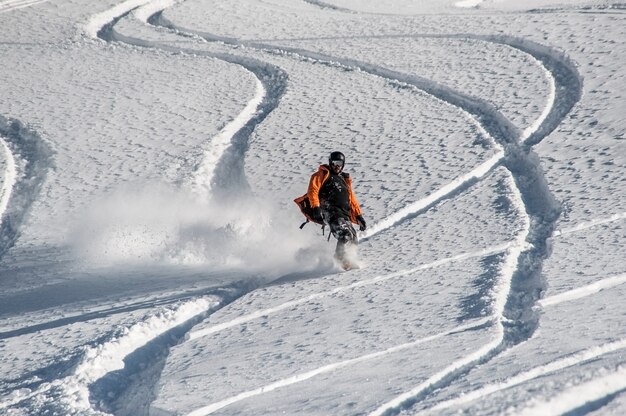 Active snowboarder riding on the mountain slope