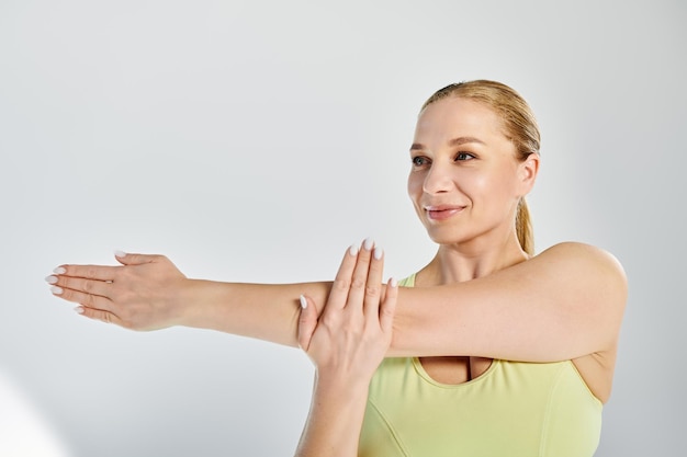 Active woman stretching in a bright studio to enhance flexibility and strength